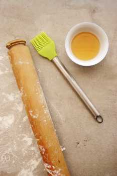 Rolling pin, pastry brush and heated honey
