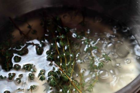 Simmering thyme, sugar and water- a simple thyme syrup